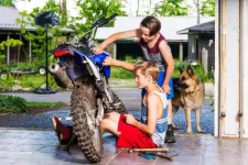 Young boys in a garage with a motocross